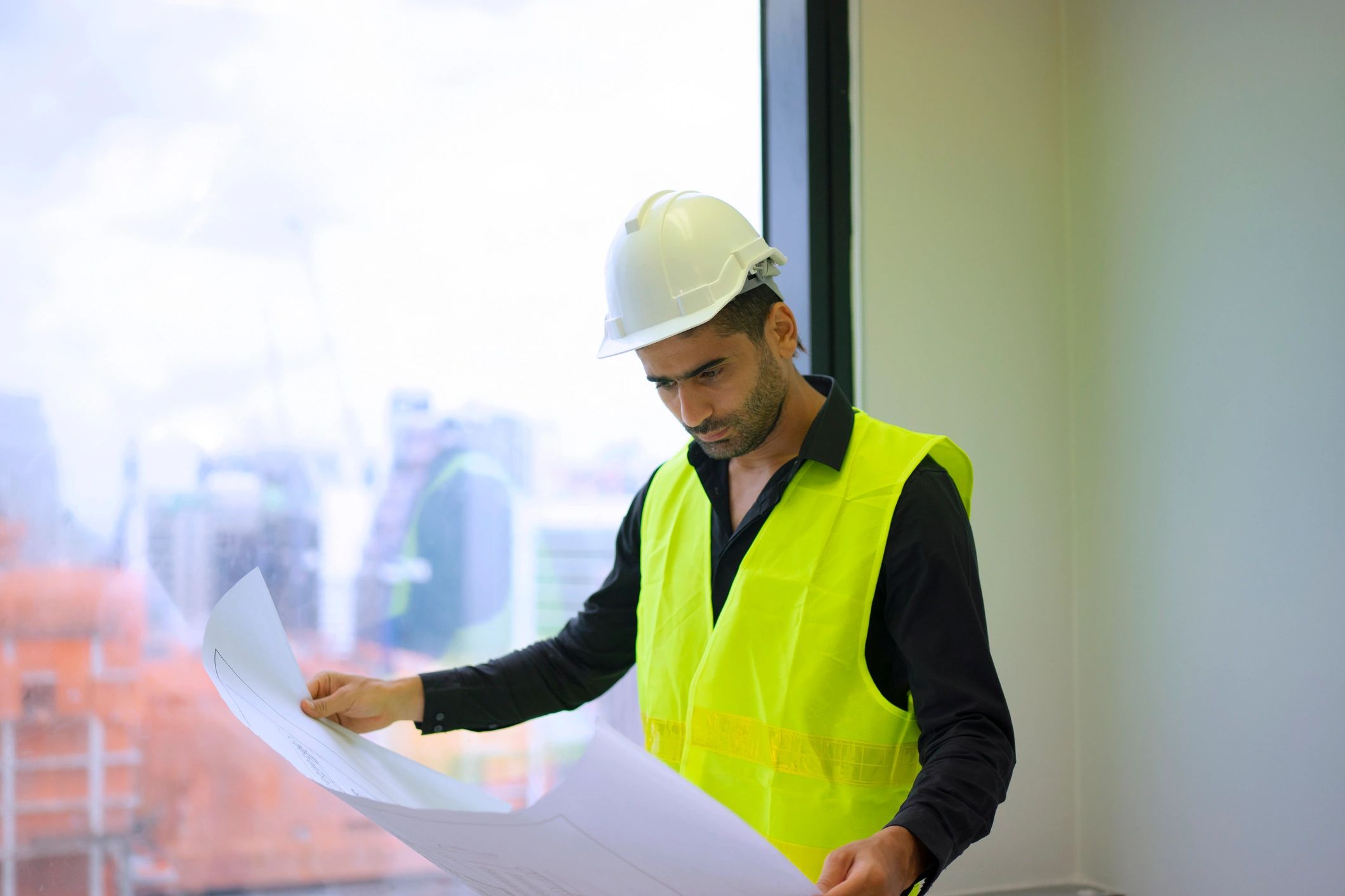 Engineer reviewing mechanical work on a building site